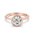 Front view of a 3 CT round cut lab grown diamond bezel engagement ring in rose gold.
