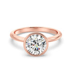 Front view of a 3 CT round cut lab grown diamond bezel engagement ring in rose gold.