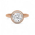 Top view of a rose gold 3 carat round lab diamond halo engagement ring on a plain shank.