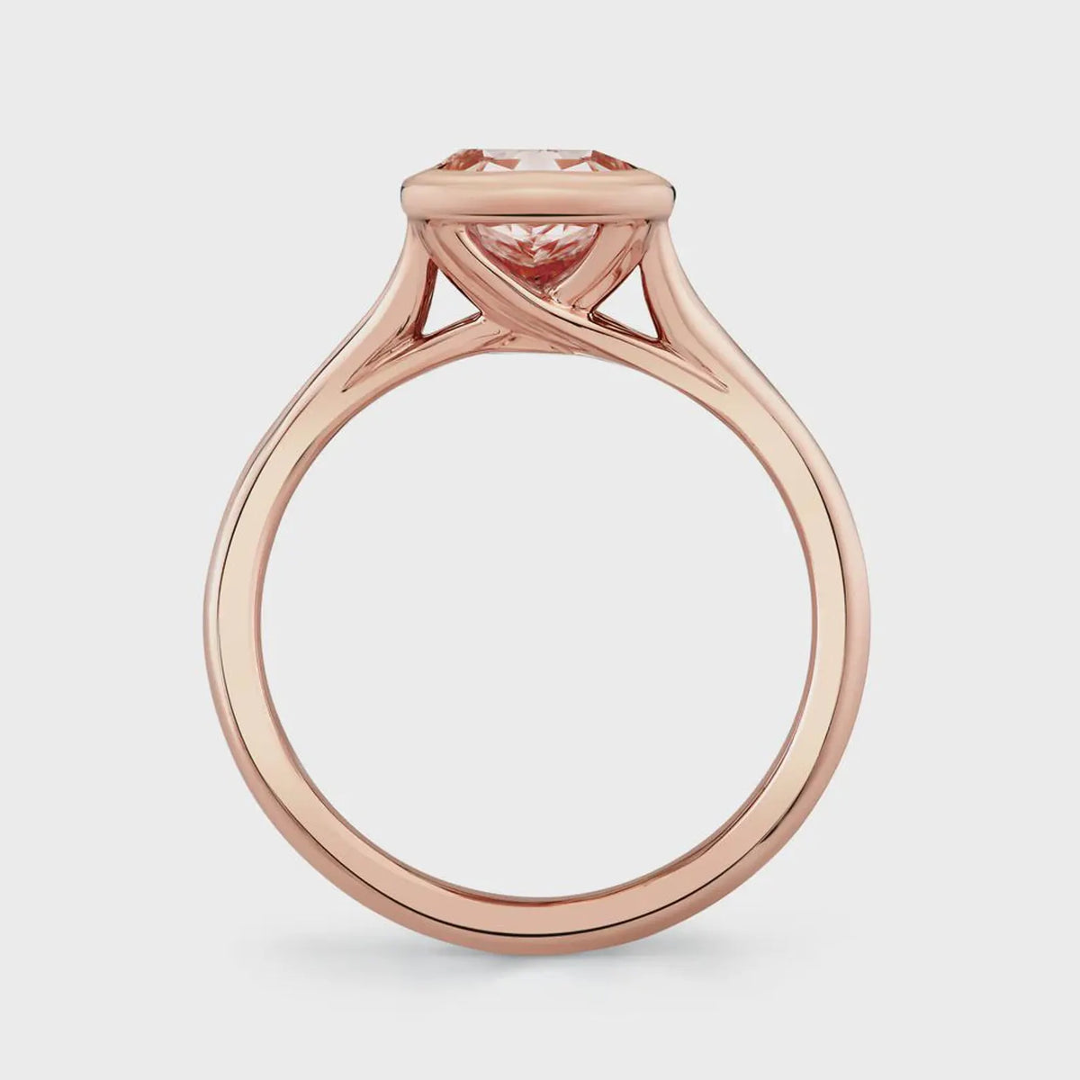 Straight side profile of a 2 carat pink cushion cut lab diamond ring set in a polished rose gold bezel setting.