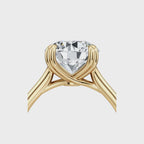 Close-up side profile of the woven cathedral basket setting holding a 2 carat round lab diamond in yellow gold.