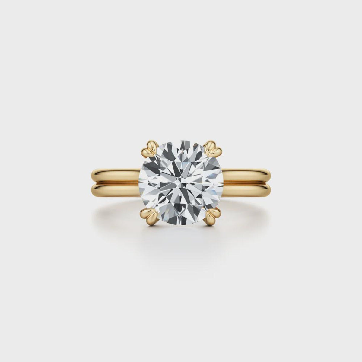 Top-down view of a 2 CT round cut lab grown diamond featuring double prongs and a parallel split band.
