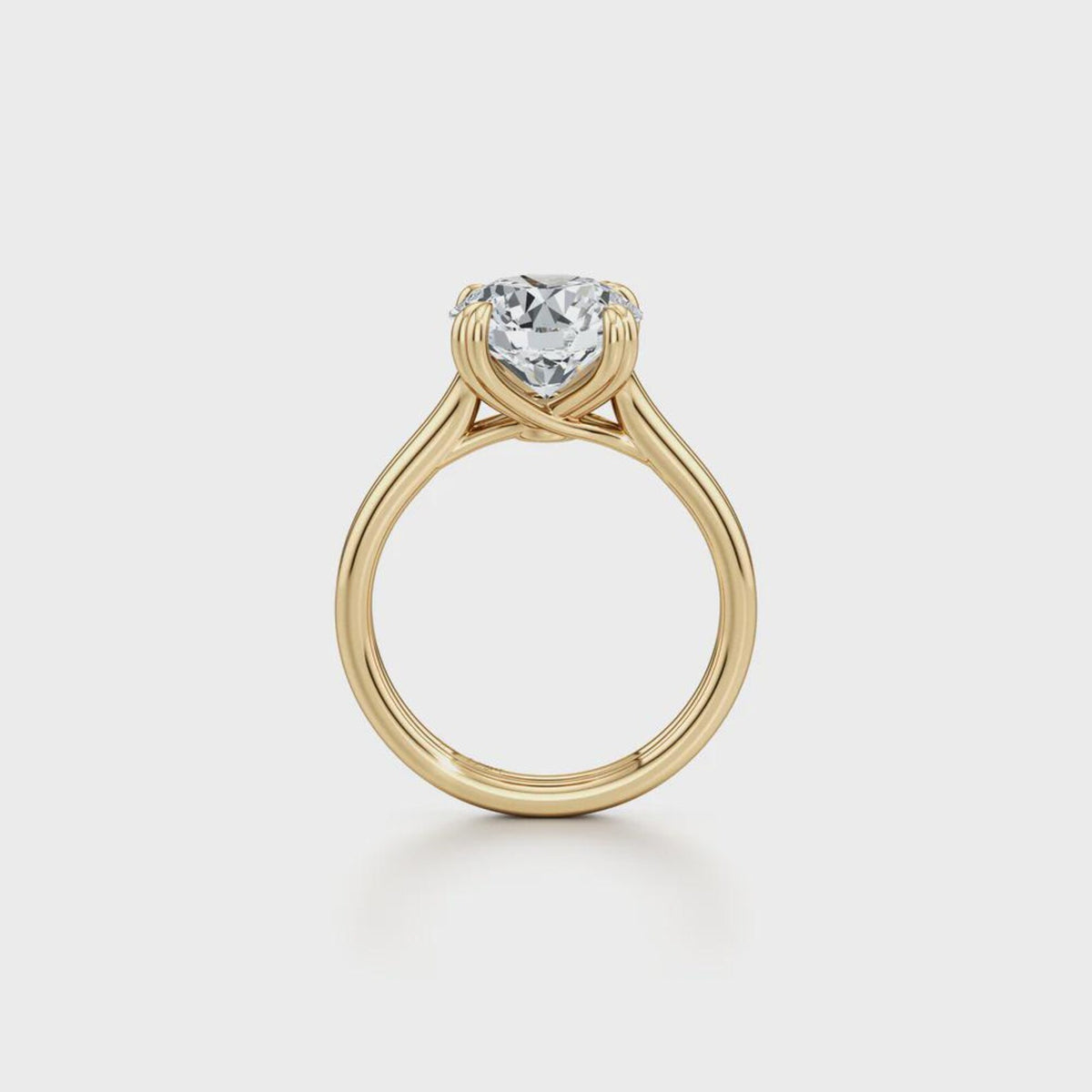 Straight side profile view of a yellow gold 2 carat round lab grown diamond solitaire engagement ring.