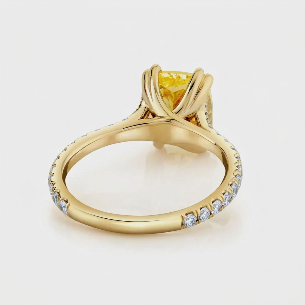 Perspective view of the undergallery and double claw setting on a yellow gold fancy yellow cushion lab diamond ring.