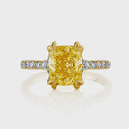 Top-down view of a 2 carat fancy yellow cushion cut lab diamond with double claw prongs and a diamond pavé shank.
