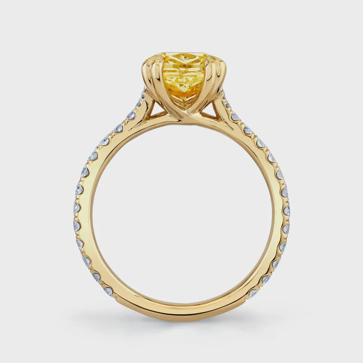 Side profile view showing the yellow gold woven crossover cathedral basket and pavé accent band.