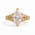 Front view of a 4 CT marquise cut lab grown diamond engagement ring in yellow gold with leaf engraving.