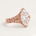Angled profile view of a rose gold 4 CT marquise lab diamond ring showcasing detailed botanical carving.