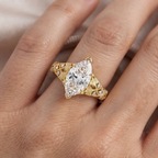 On-hand view of a 4 carat marquise cut lab grown diamond ring with vintage engraved yellow gold band.