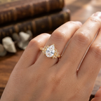 On-hand view of a 3 CT pear cut lab grown diamond ring crafted in yellow gold with vintage filigree details.