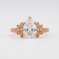 Front top-down view of a 3 CT pear cut lab grown diamond vintage engagement ring set in 14K rose gold.