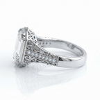 Side view of a white gold 5 CT emerald cut lab diamond ring showcasing intricate scrollwork and a polished lower band.