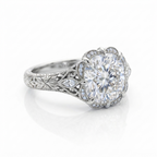 Angled view of a 3 CT cushion cut lab grown diamond ring in white gold featuring hand-engraved floral shank and scalloped halo.