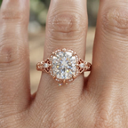 On-finger view of a 3 carat cushion cut lab grown diamond vintage ring in rose gold with floral hand carving.
