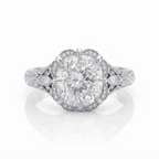 Direct front view of a white gold 3 carat cushion cut lab grown diamond engagement ring with scalloped milgrain border.