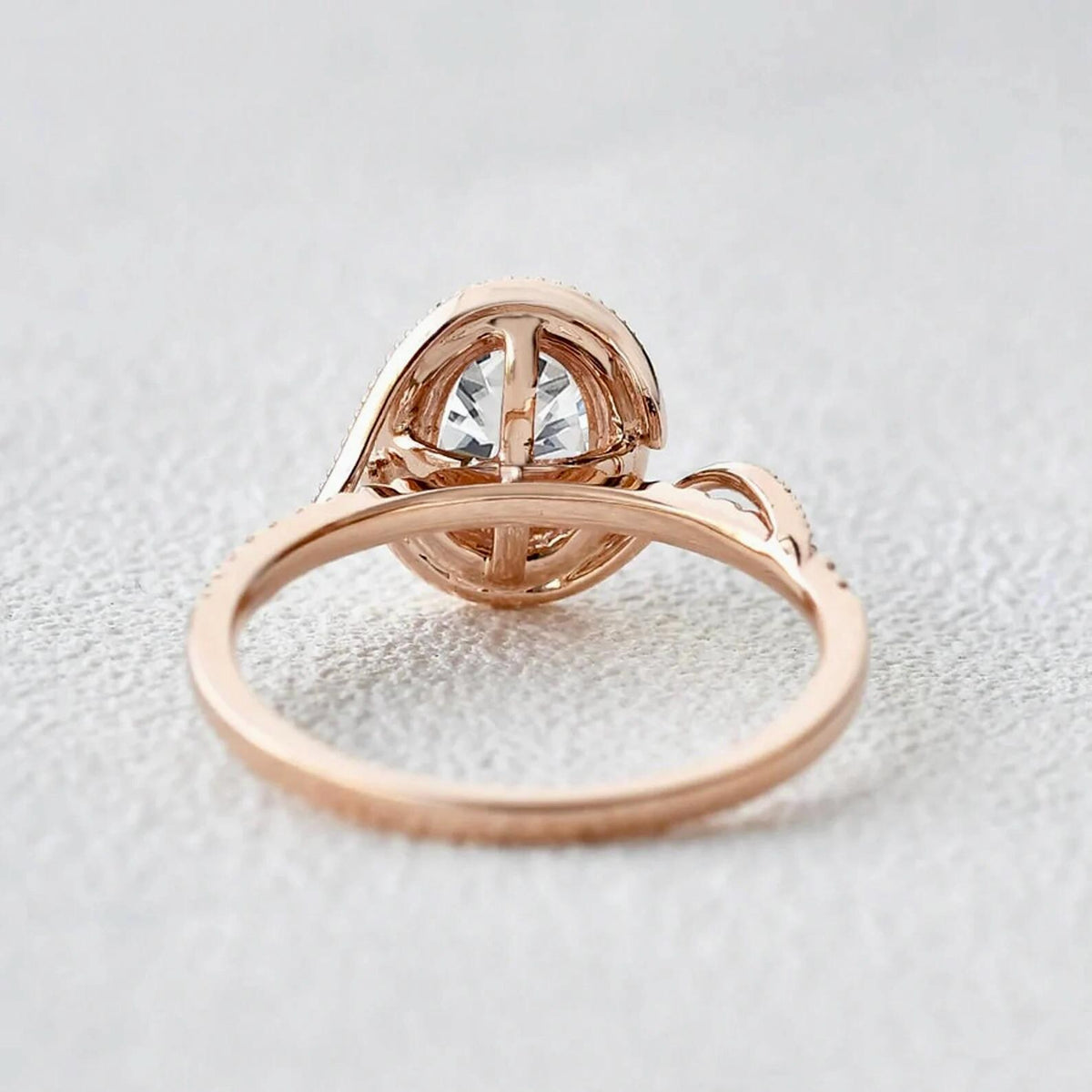 Bottom profile view showing the structural open gallery and setting architecture of the rose gold oval lab diamond ring.