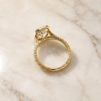 Full profile view illustrating the continuous vintage engraved pattern on the yellow gold band and undercarriage bezel setting.