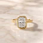 Centered top view of a 4 CT radiant cut lab grown diamond with a milgrain-detailed bezel border and engraved yellow gold band.