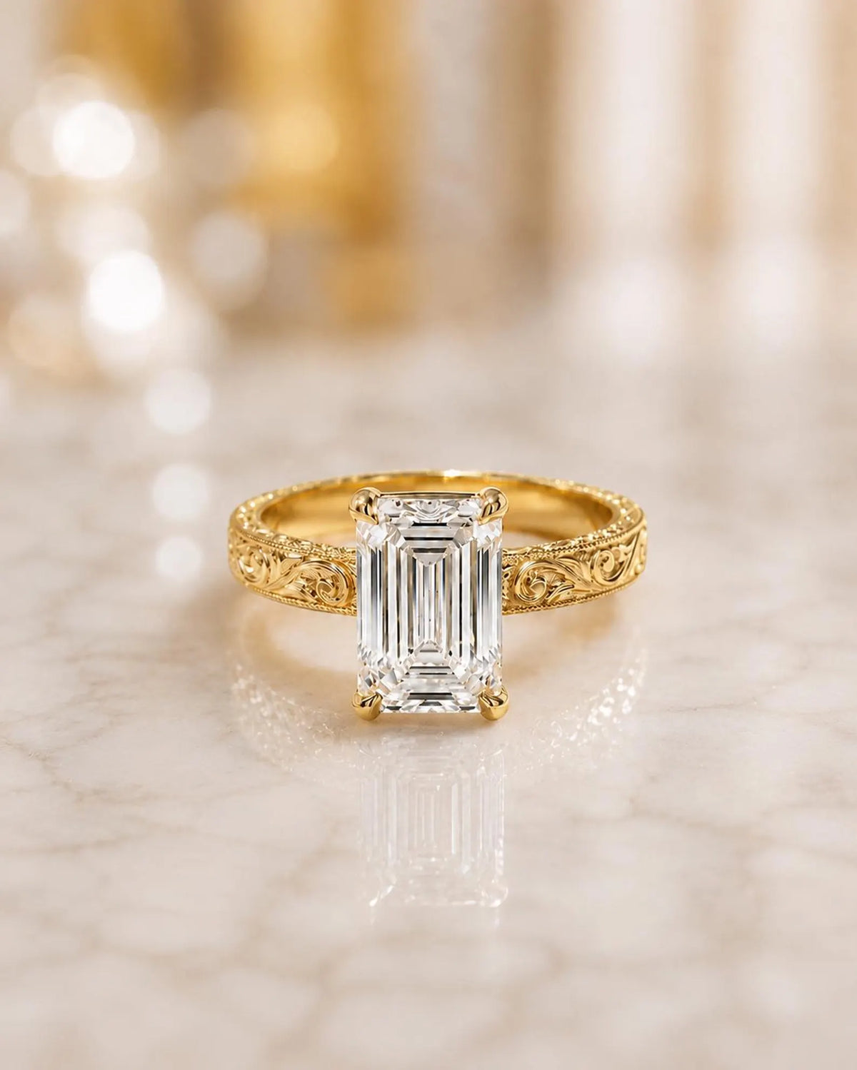 Front view of a 4 CT emerald cut lab grown diamond solitaire ring in 14K yellow gold with a hand-engraved scrollwork band.