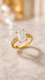 Angled top perspective view showcasing the step-cut facets of a 4 carat emerald lab diamond and milgrain engraved shank.