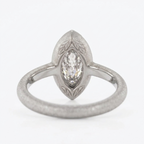 Back and profile view showing the inner smooth band and matte outer texture of a white gold marquise diamond bezel ring.
