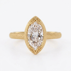 Direct top-down view of a 4 CT marquise cut lab grown diamond set in a matte yellow gold leaf-engraved bezel setting.