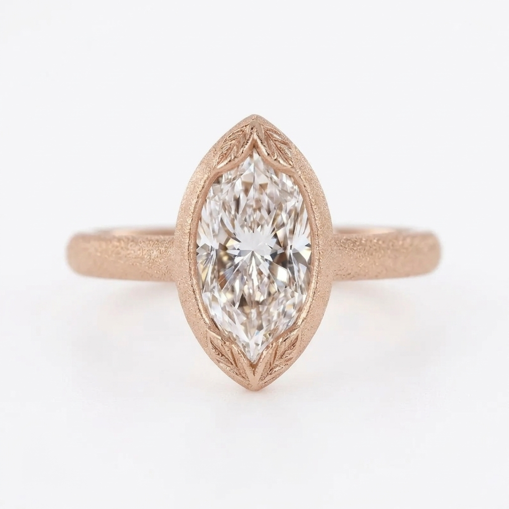 Direct top view of a 4 carat marquise cut lab diamond ring in matte rose gold with leaf-carved bezel tips.
