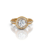 Direct top view of a 4 carat round lab grown diamond set in a vintage yellow gold milgrain halo ring with botanical carved shank.