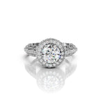 Top view of a 4 CT round lab grown diamond halo engagement ring in white gold with antique leaf filigree band.