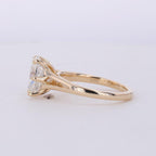 Side angled view of a 3 CT oval lab grown diamond ring in yellow gold with split shoulder band.