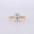 Top-down view of a 3 CT oval cut lab grown diamond set in a yellow gold split shank ring.