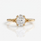 Top-down centered view of a 3 CT oval lab grown diamond engagement ring in yellow gold.