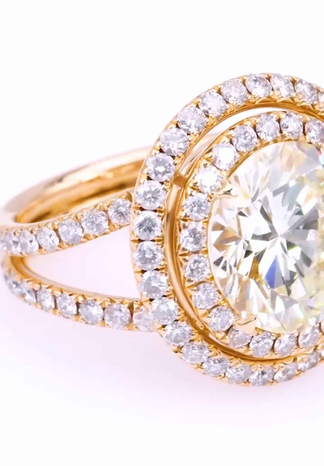 Angle top view of a 5 CT round lab grown diamond ring with double halo and diamond-set split shanks.