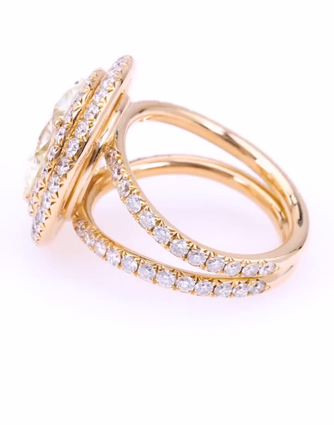 Side view of a 5 carat round lab grown diamond ring featuring a dual pavé split shank in yellow gold.