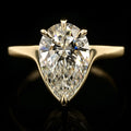 Front view of a 3 CT pear cut lab-grown diamond solitaire set in five protective yellow gold prongs on a minimal band.