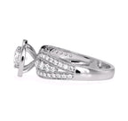 Side perspective of a white gold 3 carat round lab grown diamond halo ring showing cathedral setting and shank.