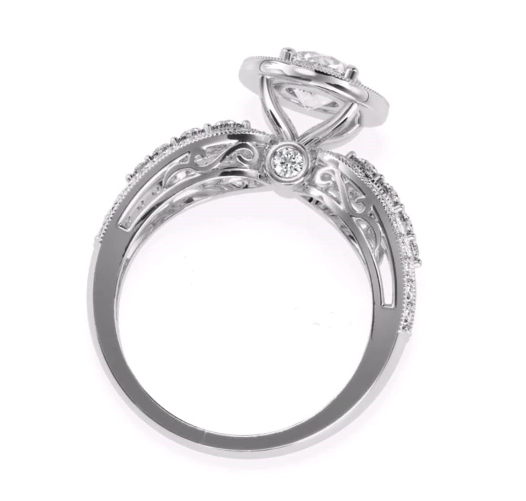 Full side profile view showing filigree scrollwork and surprise side diamond under a 3 CT round halo setting.