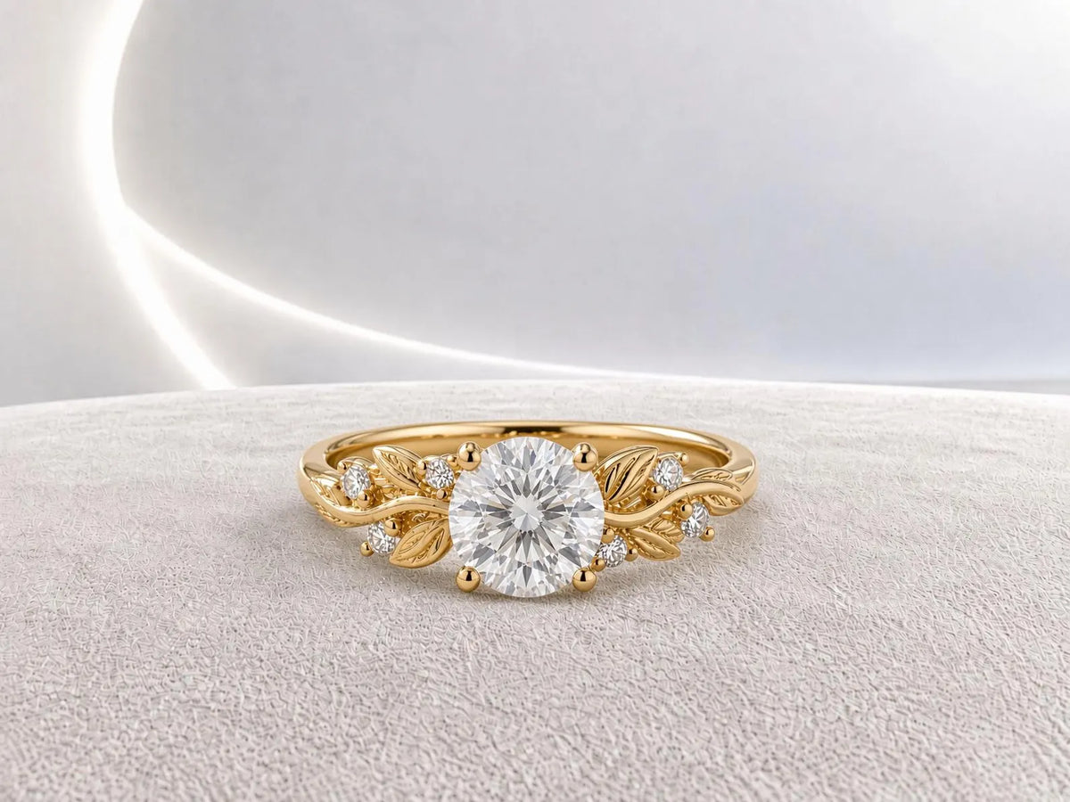Studio top view showing a 3 CT round lab grown diamond set in a yellow gold band with sculpted leaf shoulders.