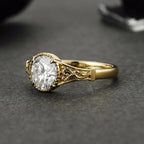 Perspective view of a 3 CT round lab grown diamond engagement ring with filigree scrollwork in yellow gold.