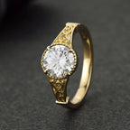 High angle view of a 3 carat round lab diamond in a scalloped coronet setting with vintage engraved shoulders.