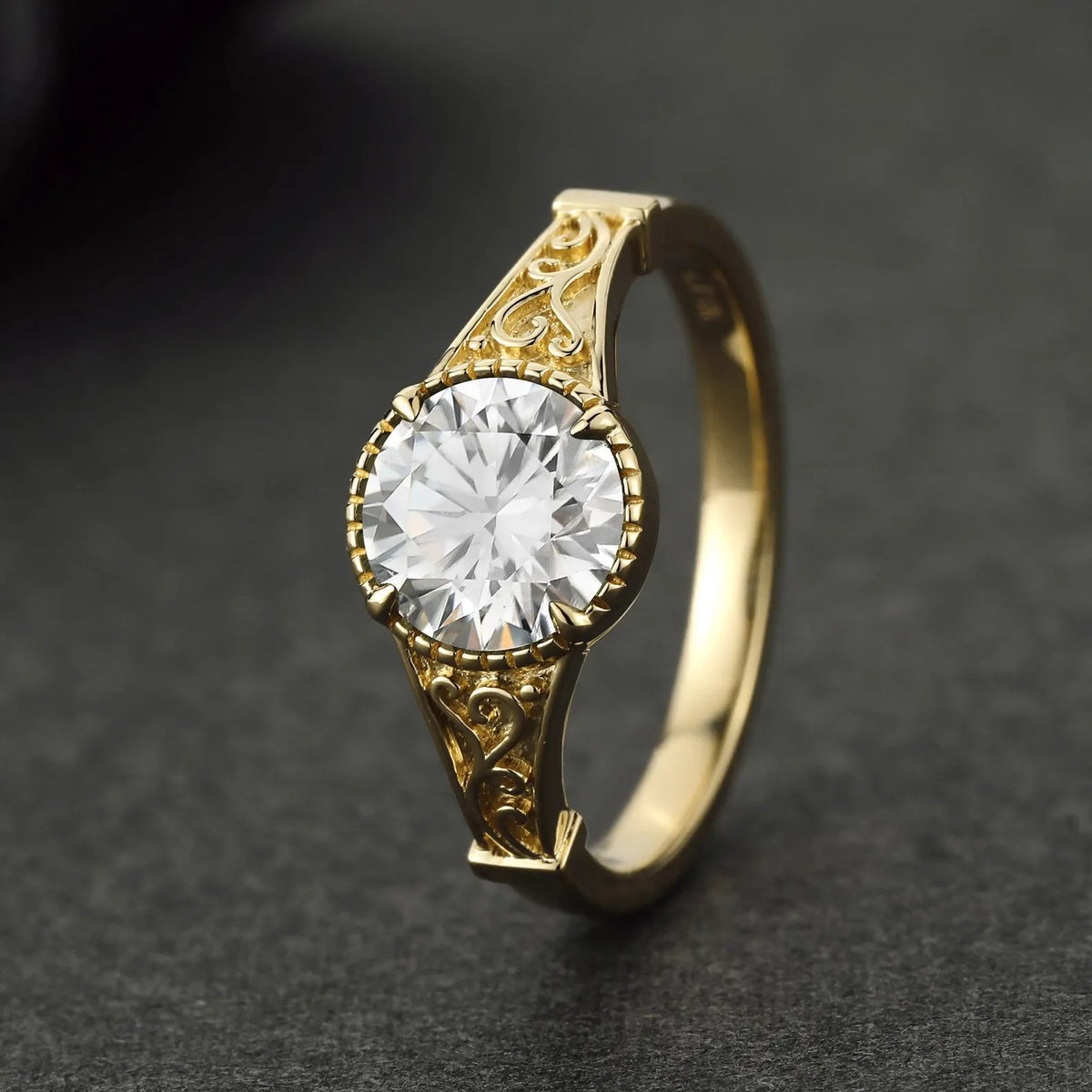 High angle view of a 3 carat round lab diamond in a scalloped coronet setting with vintage engraved shoulders.