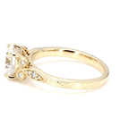 Side view showing hand-engraved scrollwork and milgrain side accents on a 3 CT round lab diamond yellow gold ring.