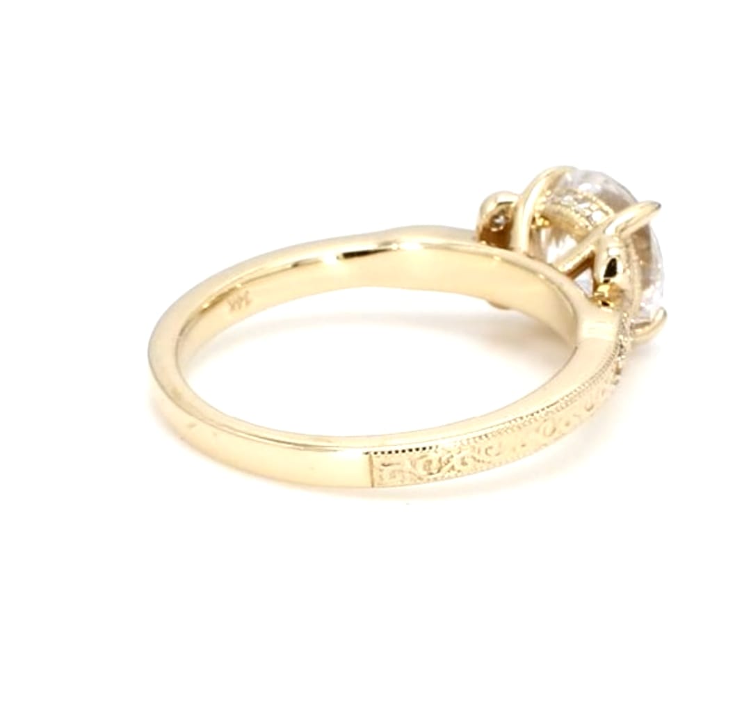 Side detail view of the basket setting and hand-engraved shank on a 3 CT round lab grown diamond 14K yellow gold ring.