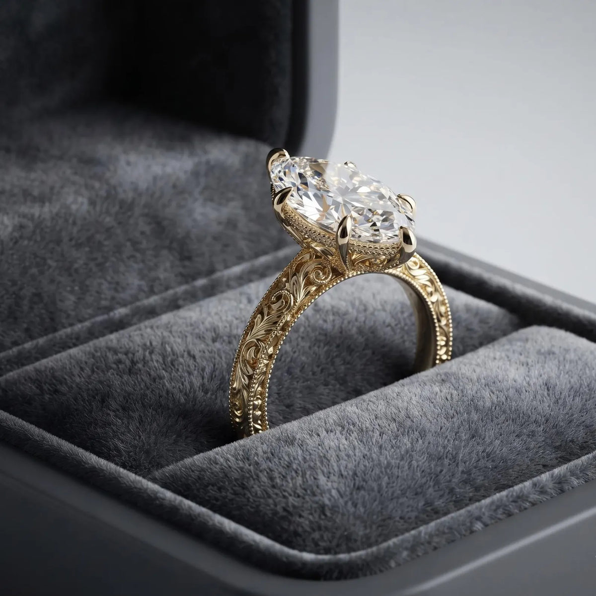 Side angle of a 4 CT marquise lab diamond ring in a velvet box displaying hand-engraved band and milgrain borders.