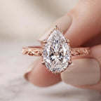 Detailed macro shot displaying the scalloped lace bezel border and hand-carved shank on a 4 CT pear lab diamond ring.