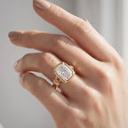 On-finger view of a 3 CT cushion cut lab diamond engagement ring in 14K yellow gold under direct natural sunlight.