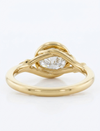 Side view displaying the open twig undergallery structure on a yellow gold 3 CT round lab diamond bezel ring.