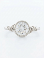 Top view of a 3 CT round brilliant lab grown diamond nature inspired bezel ring in white gold.