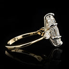 Under-gallery and profile view of a two-tone marquise diamond engagement ring displaying the seamless transition between the white gold basket and slender yellow gold shank.