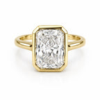 Top-down view of a 4 CT elongated radiant cut lab grown diamond ring framed in a yellow gold full bezel setting.